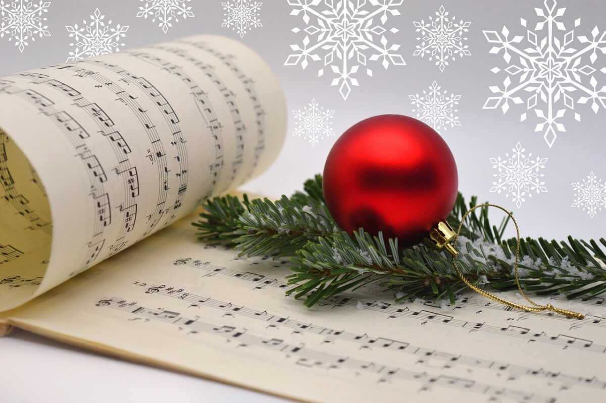 Christmas music with a Christmas bough and red Christmas ball ornament.